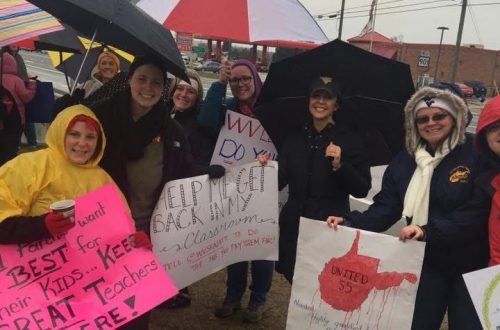 Teachers on strike standing in the rain