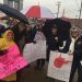 Teachers on strike standing in the rain