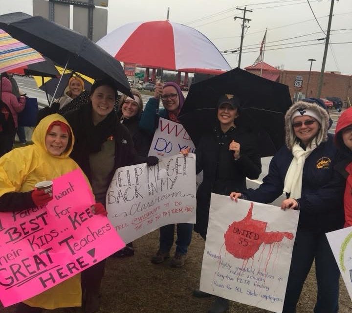 Teachers on strike standing in the rain