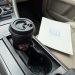 scene inside car with a coffee cup and a folder