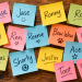 Colorful sticky notes scattered across a wooden surface, each featuring a different nickname, including Chase, Jase, Ronny, Ron, Nay, Ren, Reenie, Bow Wow, Kayla, Marcus, Shorty, Justin, Ace, Rabbit, and Toot.