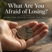 Open hand holding a coin representing fear and desire as two sides of the same coin.