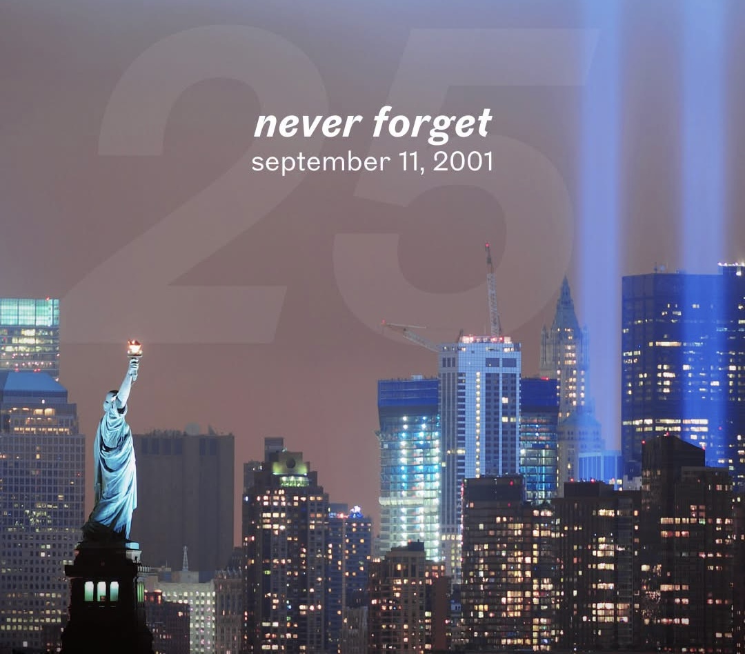 Statue of Liberty and New York City skyline with the Tribute in Light, commemorating the 25th anniversary of September 11, 2001.